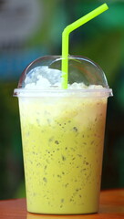 Iced green tea in a plastic cup