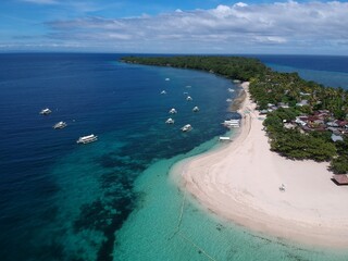 a small coral island with a white beach a drone picture 