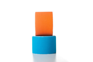 Blue and orange medical kinesiology tape on a white background. Isolate, teping, close-up
