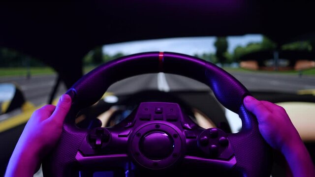 Little boy driving online racing simulator game on pc computer. Child using play station game with steering wheel. Kid playing car simulator on a video controller at home, learning to drive concept