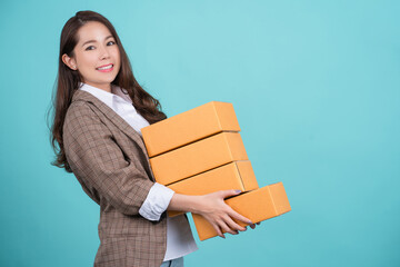 Happy Asian woman smiling and holding package parcel box isolated on background, Delivery service concept, Independent work concept.