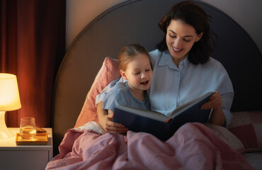 mother reading a book to her daughter
