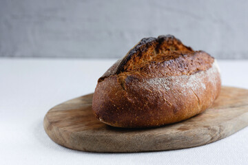 Rye bread on a board on a white tablecloth background
