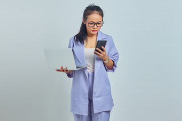 Portrait of sad young Asian woman looking at message on smartphone and holding laptop, confirmed job canceled isolated on white background