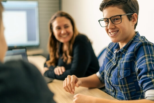 Young man with the glasses works in a team in the office.Smile young intern discusses something on a meeting