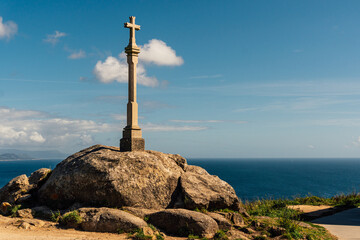 Cross at Cabo Finisterre, in Galicia, Spain. End of the famous Way of St. James. - obrazy, fototapety, plakaty