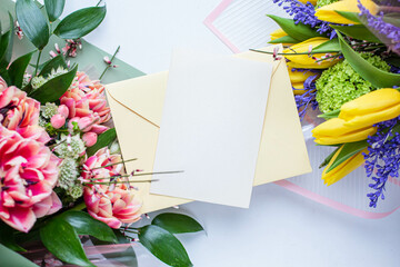 two tulip bouquets with invitation card
