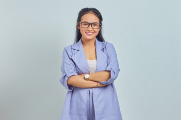 Portrait of smiling young asian woman standing with crossed arms, looking at camera isolated on white background