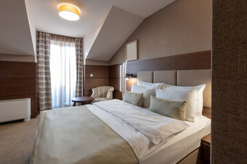 Interior of a luxury hotel double bed bedroom in the morning