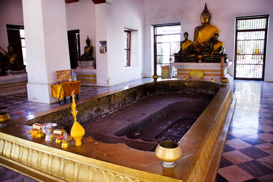 Ancient ruin antique old buddha statue and footprint of buddha at Wat Prasat Nakhon Luang Temple for thai people travel visit and respect pray on December 4, 2021 in Phra Nakhon Si Ayutthaya, Thailand