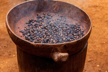 Roasted coffee beans in a rustic bowl