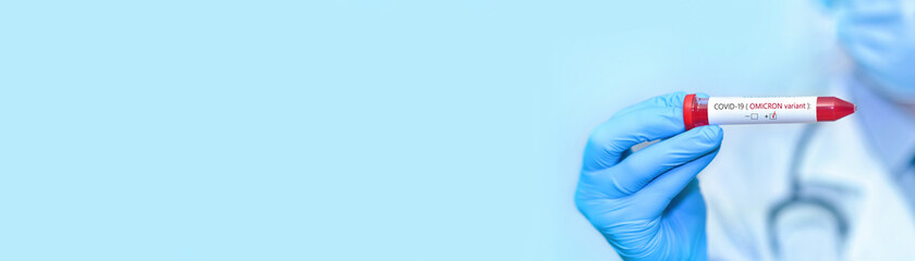 Fototapeta premium Doctor holding a test blood sample tube positive with Omicron variant or strain COVID-19.Banner. Copy space