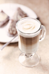 Coffee with milk on bright stone background. Close up.