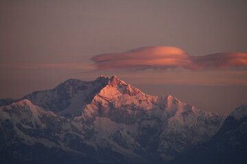 Dawns first glimpse reflected on the mighty Mt. Kanchenjunga. The highest peak of the Himalayan...