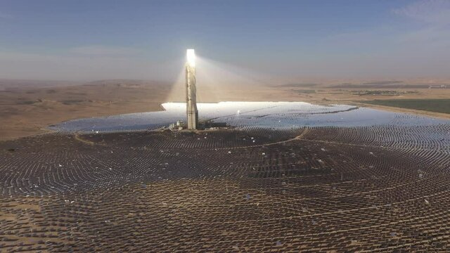 Drone shot of solar power tower in beautiful desert landscape in Southern Israel. Sustainble energy production and solution to global warming.
