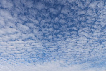 Beautiful blue sky view of lovely small clouds.