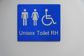 Unisex and Disabled toilet sign on white wall with Braille writing - 481104345