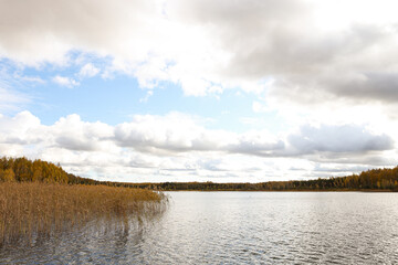 Cloudy Overcast autumn view with small river and cloudy sky.