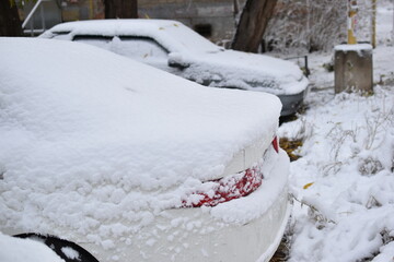 Cars in the winter in the snow after a snowfall