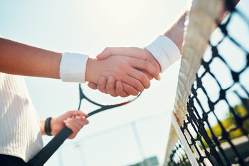 Congratulations champ. Cropped shot of two unrecognizable tennis players shaking together outdoors on the court.