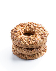 Stack of sugar ring cookies with monkey nuts isolated on white