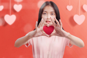 Asian woman holding the red heart