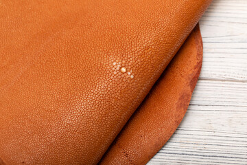 natural colored brown red sand rays leather on the wooden table	
