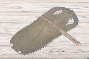 natural colored grey rays leather on the wooden table	
