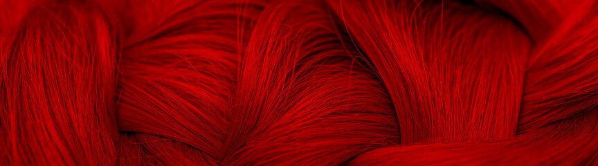 Red-haired Beautifully laid braid carroty curls.Female long red hair close-up as a background. Hair care shampoo and balsam for colored hair. Hairdressing procedures. Copy space with space for text.