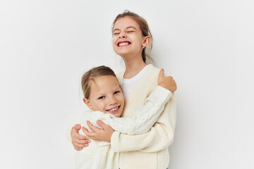 two little girls in sweaters posing friendship fun