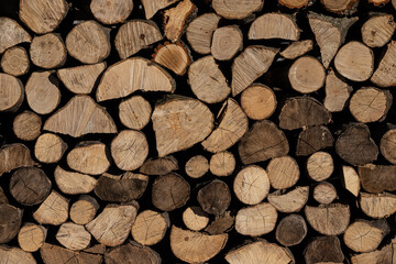 Pile of stacked triangle firewood prepared for fireplace and boiler
