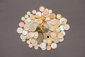 Different money coins. US dollars money and euro as a background on a flat lay. Savings and economy. Coins of different denominations from different countries. Inflation and exchange rates.