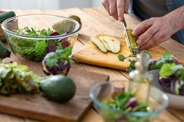 Cooking healthy and tasty food concept. Male hands preparing vegetarian food at home kitchen