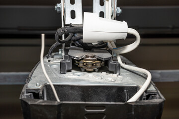 Electric lifting mechanism for a home garage door with a chain.