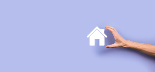 Naklejka premium Real estate concept, businessman holding a house icon.House on Hand.Property insurance and security concept. Protecting gesture of man and symbol of house