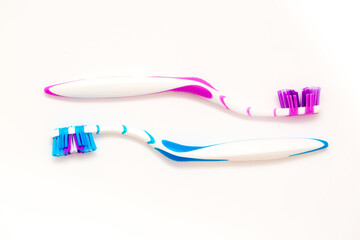 Toothbrushes on a white background. Oral hygiene. Male and female couple, family hygiene and relationships.