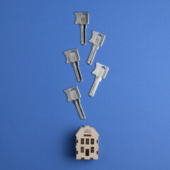 Conceptual composition: House keys and house model. Top view, flat lay. Real estate purchase concept.