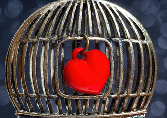 Shiny red heart in a vintage birdcage