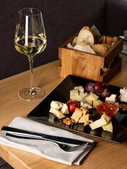 Glass of wine with appetiser on table in restaurant interior background. Italian and French food style for menu - 481114727