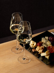 Glass of wine with appetiser on table in restaurant interior background. Italian and French food style for menu - 481114728