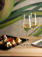 Glass of wine with appetiser on table in restaurant interior background. Italian and French food style for menu - 481114729