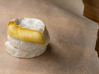 French cheese camembert or brie close up on wooden table. Food ingredient for snack, starter or appetiser  - 481114736
