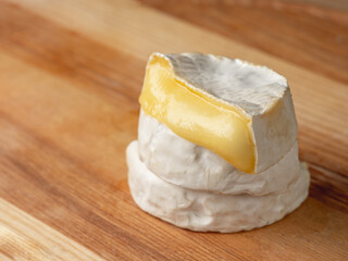 French cheese camembert or brie close up on wooden table. Food ingredient for snack, starter or appetiser  - 481114739