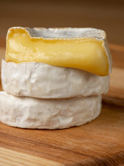 French cheese camembert or brie close up on wooden table. Food ingredient for snack, starter or appetiser  - 481114745