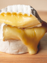 French cheese camembert or brie close up on wooden table. Food ingredient for snack, starter or appetiser  - 481114746