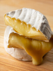 French cheese camembert or brie close up on wooden table. Food ingredient for snack, starter or appetiser  - 481114747