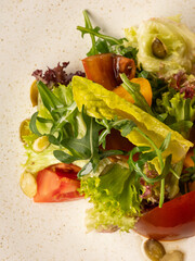Mix salad with fresh vegetables on plate closeup - 481114772