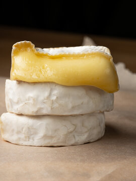 French cheese camembert or brie close up on wooden table. Food ingredient for snack, starter or appetiser 