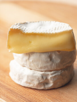 French cheese camembert or brie close up on wooden table. Food ingredient for snack, starter or appetiser 