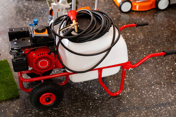 Red petrol engine in salesroom of gardening tools store.